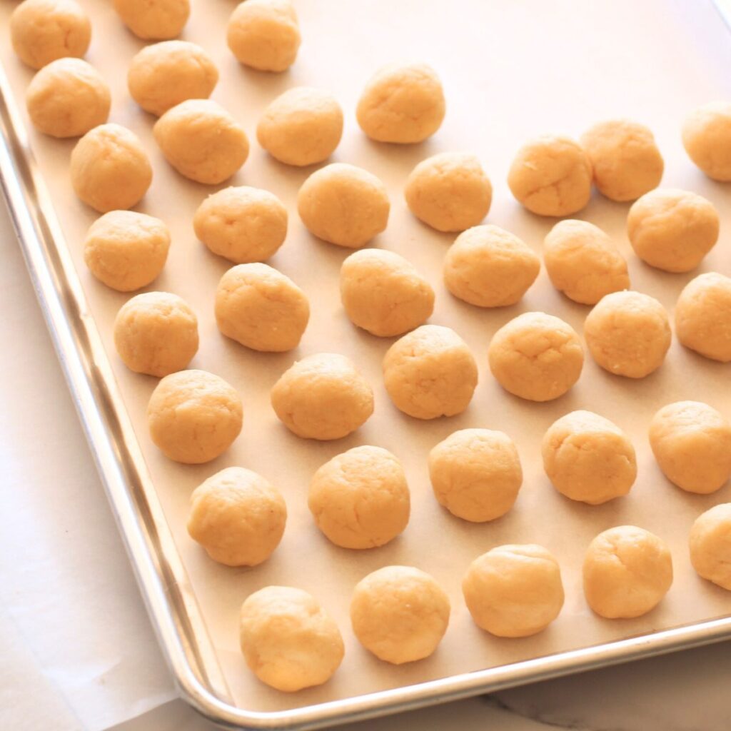 A tray, almost full, of Stroopwafel dough balls